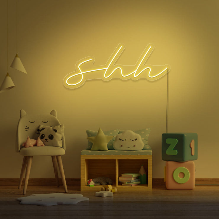 yellow shh neon sign hanging on kids bedroom wall