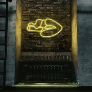 yellow smoking lips neon sign hanging on bar wall