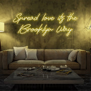 yellow spread love the brooklyn way neon sign hanging on living room wall