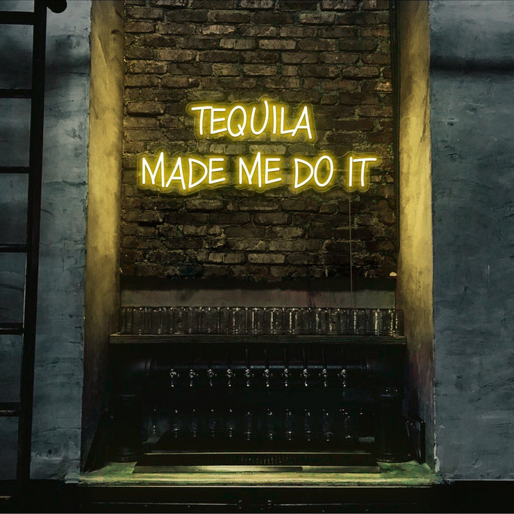 yellow tequila made me do it neon sign hanging on bar wall