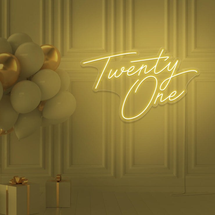yellow  twenty one neon sign hanging on wall with balloons