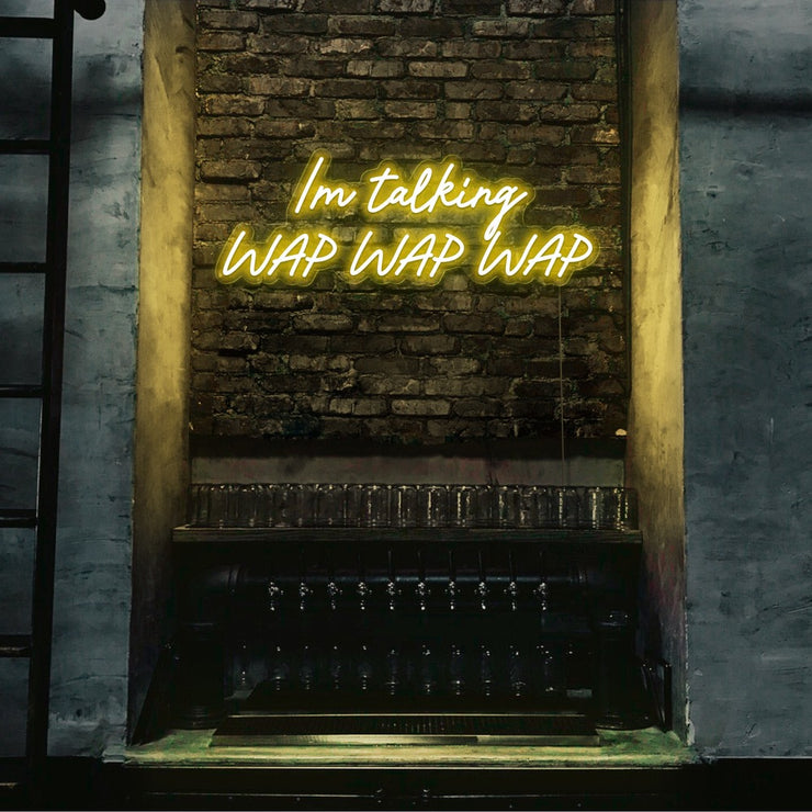 yellow im talking wap wap wap neon sign hanging on bar wall