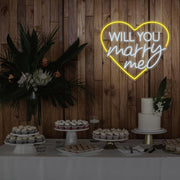 yellow will you marry me heart neon sign hanging on timber wall above dessert table