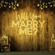 yellow will you marry me neon sign hanging on timber wall